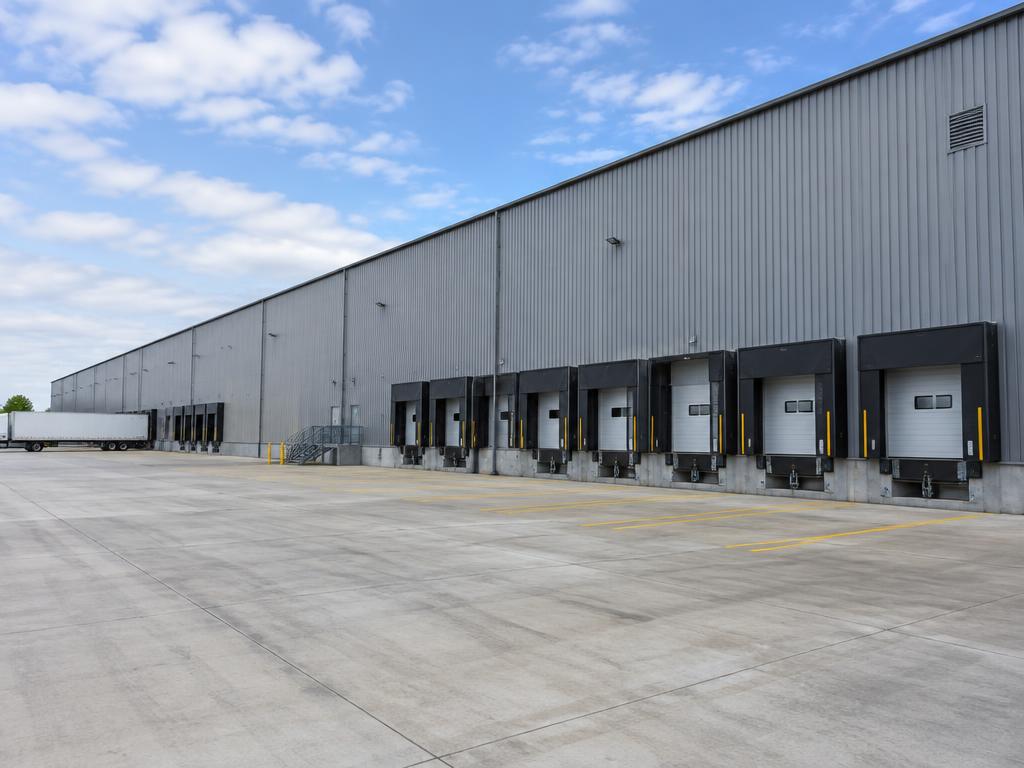 Long industrial steel warehouse with a row of loading docks